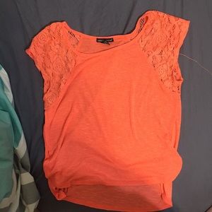 peach shirt with lace detailing on the sleeves